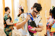 © kleberpicui - Care during Carnival. Man using sunscreen during carnival block