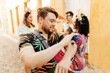 © kleberpicui - Care during Carnival. Man using sunscreen during carnival block