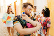 © kleberpicui - Care during Carnival. Man using sunscreen during carnival block