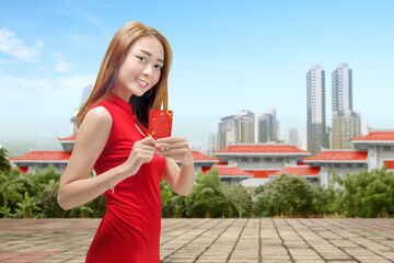 Sticker - Asian Chinese woman in a cheongsam dress holding red envelopes