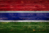Fototapeta Tęcza - The national flag of Gambia. is painted on a camp of even boards nailed with a nail. The symbol of the country.