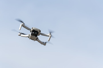 Drone flying with the light blue sky on the background