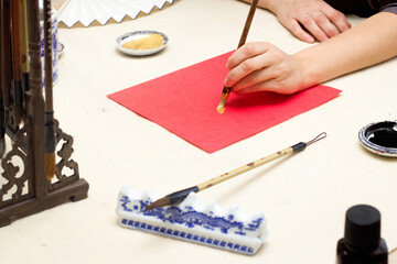 chinese calligraphy Master writing new year golden character Fu means Blessing, Good Fortune, Luck