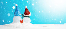 Winter Snow Snowman Background Panoramic Banner Panorama Holiday Greeting Card - Little Cute Snowman And Red Heart From The Back Sits On Snow In Snowy Landscape With Snowflakes Blue Sky And Sunshine