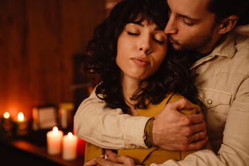 White happy couple hugging during romantic night at home