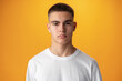 © fotofabrika - Portrait of a teen boy smiling against yellow background