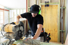 Carpenter At Work On Home Construction Site