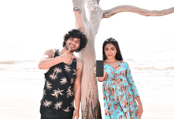 young happy couple front pose at beach indian pakistani model