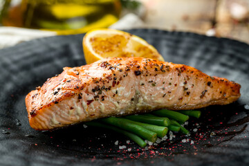 Wall Mural - Salmon steak on the grill on black plate macro close up