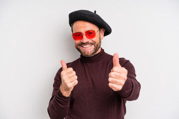 middle age man feeling proud,smiling positively with thumbs up. actor artist concept