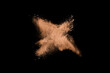 Closeup of orange dust particle splash isolated on black   background. Powder explosion.