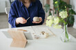 © Dina - woman sculpting a pumpkin out of clay with tools - hobby and DIY project at home