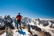 © baisa - Young man trekker playing guitar and singing song on top of Pik Uchitel peak . Ala Archa Alpine National Park Landscape near Bishkek, Tian Shan Mountain Range, Kyrgyzstan, Central Asia.
