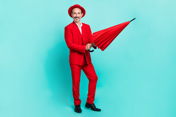 Sticker - Full body photo of mature cheerful man open umbrella well-dressed isolated over turquoise color background