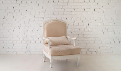 Poster - Beige armchair in the interior. . Light stylish modern interior.