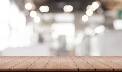 Wall Mural - Empty wooden table top with lights bokeh on blur restaurant background.