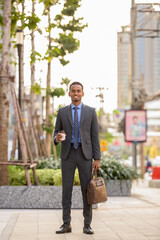 Wall Mural - Full length shot of black businessman wearing suit in city