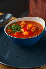 Wall Mural - Bowl of minestrone soup on a table, close up