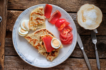 Sticker - Flatbread with boiled egg, salted salmon, tomato. Coffee, breakfast, top view, wooden background