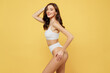 Side profile view sexy satisfied attractive young brunette caucasian woman 20s wear white underwear with perfect fit body standing posing hold head isolated on plain yellow color background studio