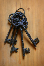 A Bunch Of Keys On Wooden Floor.