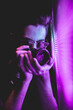 © Ramacastelo - Male photographer at a party with neon lights.