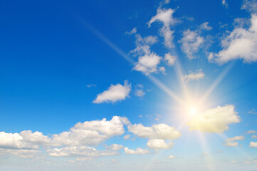 Poster - Blue sky , sun and beautiful white clouds.