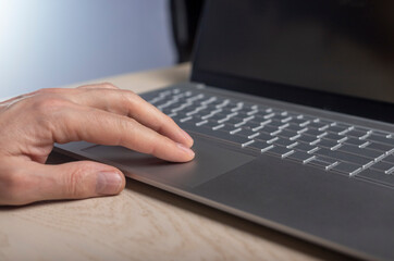 Poster - Hand on laptop touchpad, tapping and scrolling with fingers close up.