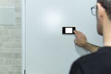 Man Touching And Watching With The Digital Peep Hole, With White Background