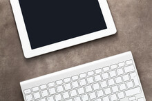 White Tablet Computer And Keyboard On Grunge Background