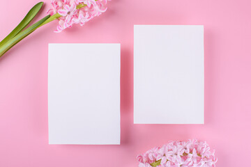 Wall Mural - Two Blank wedding invitation stationery card mockup on pink background with hyacinth flowers, 5x7