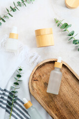 Wall Mural - spa natural beauty products set and eucalyptus leaves on stone table.