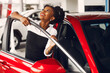 © prostooleh - Stylish black woman in a car salon