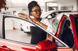 © prostooleh - Stylish black woman in a car salon