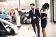 © prostooleh - Elegant couple in a car salon