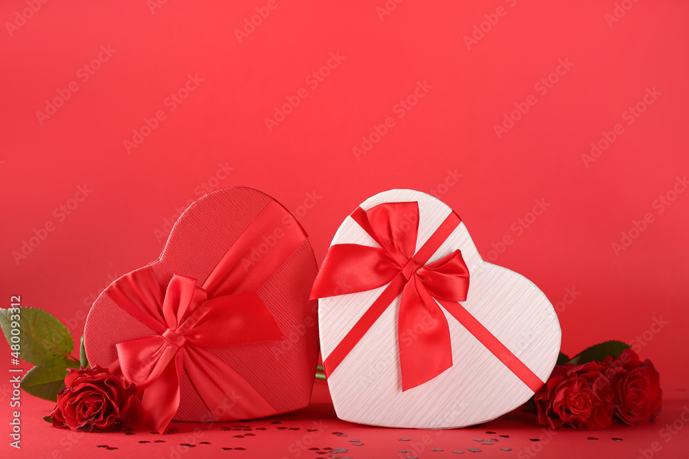 Gift boxes for Valentine's Day and roses on red background