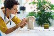 © DimaBerlin - Professional sculptor girl creating ceramic tableware in studio. Young woman artist work with wet clay jug shaping handmade dishes. Creative craftswoman in workshop space. Pottery art hobby concept
