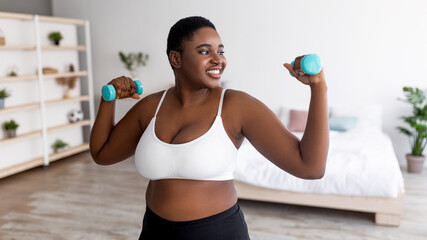 plus size young black lady exercising with dumbbells at home during covid lockdown, banner design
