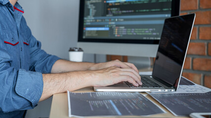 Leinwandbilder - Young Professional programmer working at developing programming and website working in a software develop company office, writing codes and typing data code, Programming with HTML, PHP and javascript