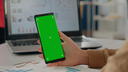Poster - close up of woman holding isolated green screen vertically on phone. company worker using mock up ch