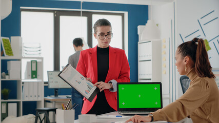 Poster - team of coworkers using green screen on laptop to work on startup business. women working with mock 