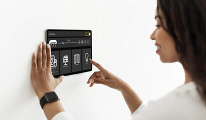 Poster - Pretty woman using smart home device, pushing button on pad