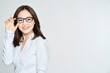Young business woman posing with glasses on studio shot