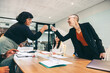 © Jacob Lund - Cheery businesswomen fist bumping each other before a meeting