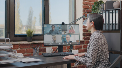 Wall Mural - Business woman talking to colleagues on online video call, doing teamwork on project planning. Person using remote video conference to have conversation about development. Teleconference