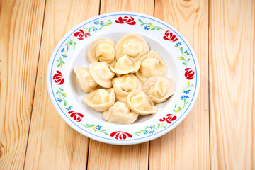 Sticker - Tasty stuffed dumplings on wooden surface.