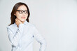 Young business woman posing with glasses on studio shot