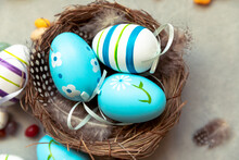Happy Easter Concept. Preparation For Holiday. Colorful Decorated Blue Easter Eggs In Nest On Concrete Stone Grey Background. Simple Minimalism Flat Lay Top View. Postcard Background Banner On Easter