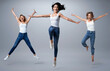 © konradbak - Group of beautiful  young women wearing white shirt and denim jeans having fun