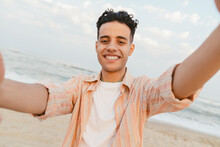 Young Middle Eastern Man Smiling While Taking Selfie Photo